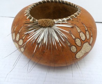Bear paw gourd with porcupine quills and pine needles by Durrae Johanek